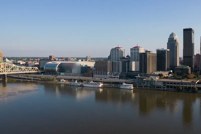 Louisville's riverfront skyline across the Ohio River on a clear late-summer day